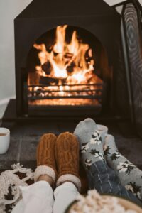 Relaxing at home with warm socks and hot drinks by the fire.